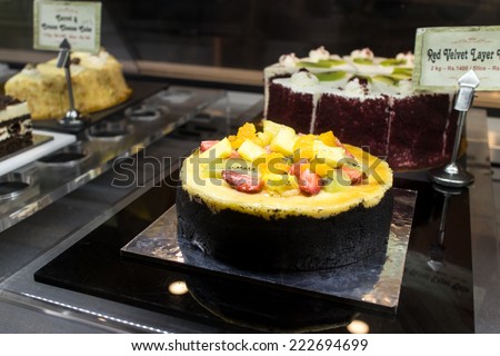 beautiful chocolate cake with fresh berry fruits. cakes in a cake shop. Bakery sale displayed.