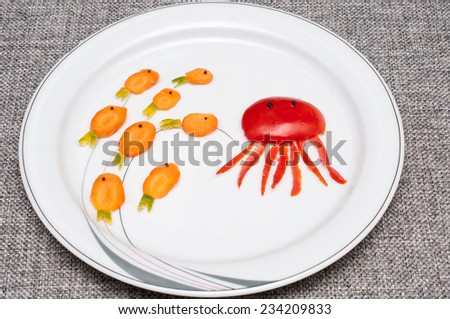 tomato in the shape of octopus and carrot in the shape of fish with green chilly.Food art .Food decoration.Food carving.