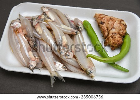 Raw Fish ready to cook with ginger onions and green chili. silver fish