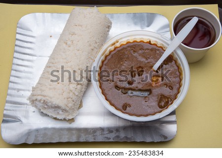 Steamed rice cake with beef curry Kerala India breakfast. Puttu