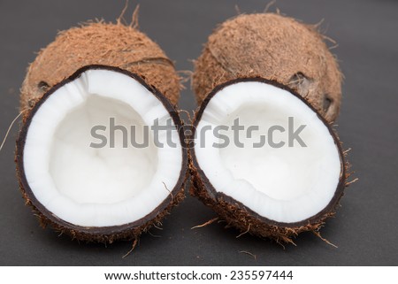 Coconuts cut in half and whole coconuts