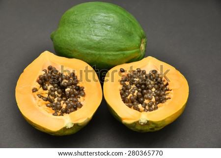 whole and a half ripe papaya.  Fresh papaya fruit. Natural facial mask.