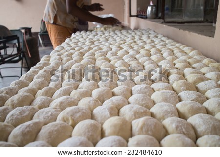 Fresh pizza dough ready for baking. Wheat balls ready for making Indian bread, chapati or roti
