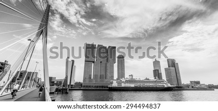 Black and white cityscape of Rotterdam head of south with the cruise ship De Rotterdam and next to the Erasmus bridge