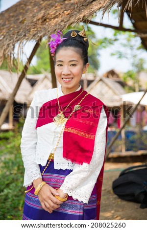 Thai woman dressed in a traditional Northern Thailand Silk Dress