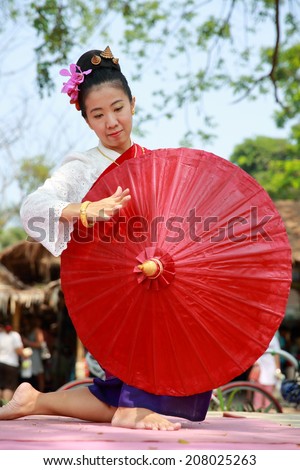 Thai woman dressed in a traditional Northern Thailand Silk Dress