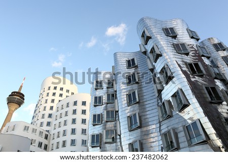 DUSSELDORF, GERMANY - FEBRUARY 2, 2013: Frank O. Gehry's distorted buildings in the media harbor district with the rhine tower as a backdrop on February  2, 2013 in Dusseldorf.