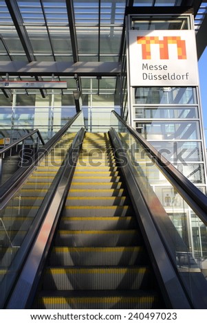 DUSSELDORF, GERMANY - JANUARY 12, 2014: Escalator at tram station Dusseldorf trade fair north entrance with a large Messe logo on January 12, 2014 in Dusseldorf.
