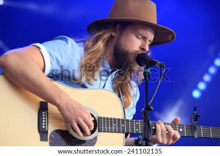 HAMBURG, GERMANY - AUGUST 15, 2014: Singer songwriter Ian Hooper of the band Mighty Oaks on stage at MS Dockville Festival on August 15, 2014 in Hamburg.