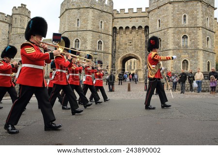 WINDSOR, UNITED KINGDOM - APRIL 22, 2014: British Queen's Guards perform the changing of the Guard in front of the entrance of Windsor Castle at the foot of Castle Hill on April 22, 2014 in Windsor.