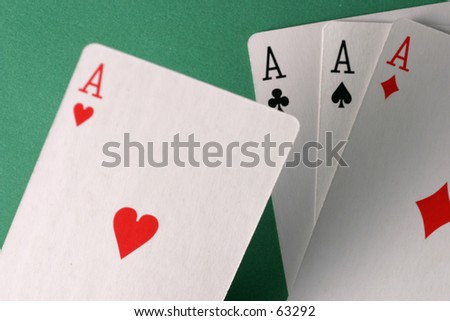 Ace of hearts held over other aces