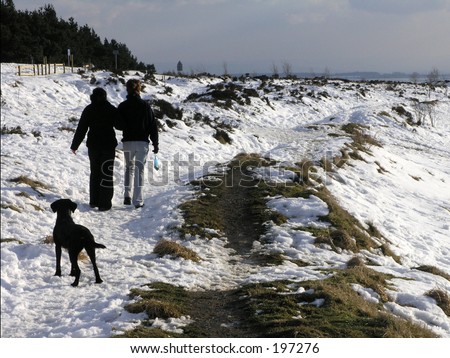 Young couple walking with dog in the Hole of Horcum, North Yorkshire, England, UK.