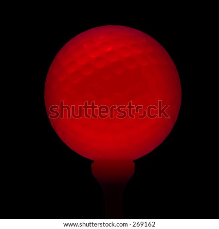Red golf ball on black