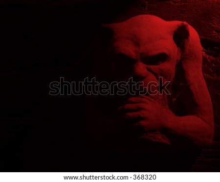 Gargoyle figure with red lighting effect