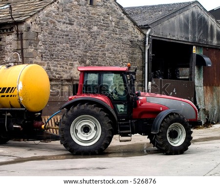 Tractor in farm yard. Grassinton, Yorkshire, UK.