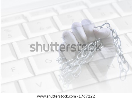Chained hand overlaid over keyboard