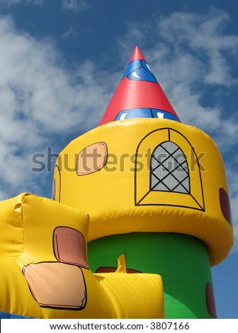 Bouncy castle tower with cloudy blue sky
