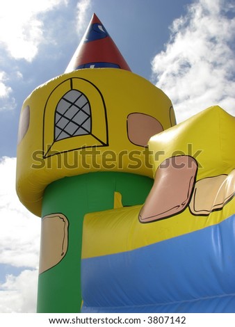 Bouncy castle tower with cloudy sky behind