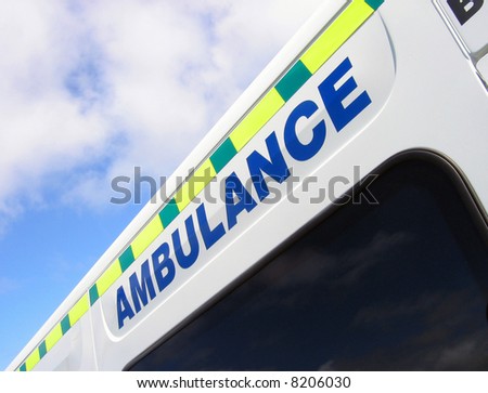 Close-up of ambulance sign against blue cloudy sky