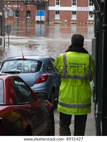 Man from environmental agency report on flood situation. York, North Yorkshire, UK.