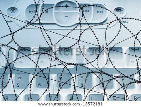 Conceptual image of barbed wire and computer keyboard