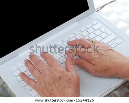 Close-up of elderly woman using computer laptop
