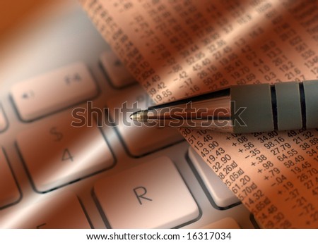 Financial newspaper rests on a computer laptop with lighting effect