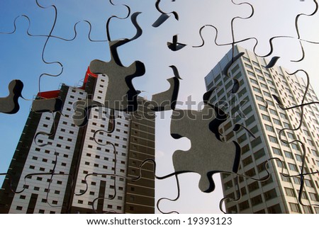 Jigsaw puzzle overlaid with city tower blocks