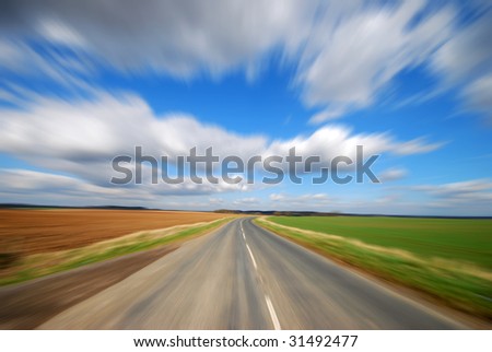 Zoom effect applied to country road on sunny day