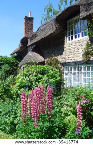 Postcard view of English thatched cottage garden