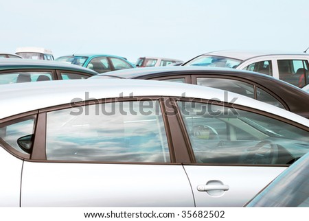 Telephoto view of cars parked in crowded car park