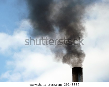 Close up of black smoke rising from chimney