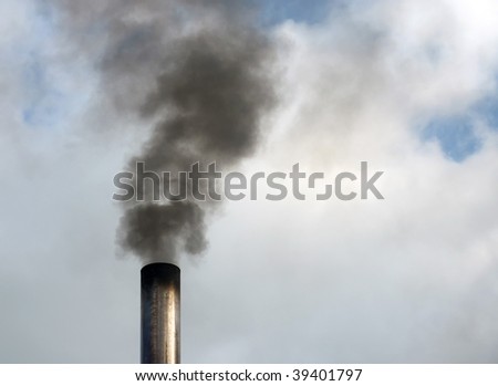 Close up of black smoke rising from chimney