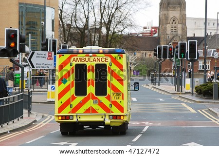 Speeding ambulance in city street responding to emergency call