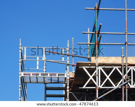 View of scaffolding tower against blue cloudless sky