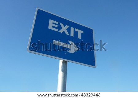 Closeup of exit traffic sign against cloudless blue sky