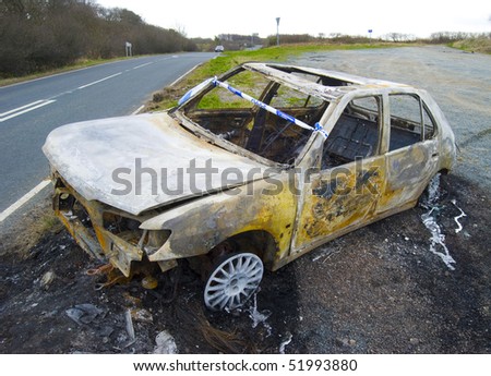 Vandalised car lies abandoned by side of road