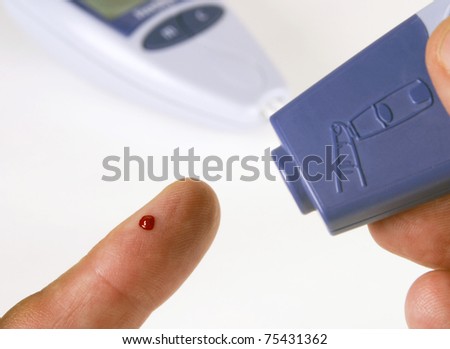 Finger showing blood using glucose testing tool