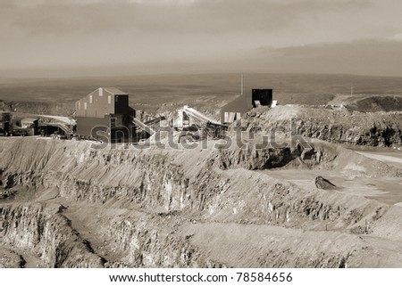View of stone quarry showing mining equipment.