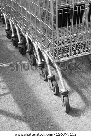 Line of empty supermarket trolleys at local store.