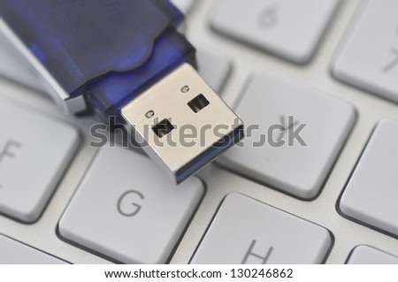 Closeup of USB memory stick resting on computer keyboard