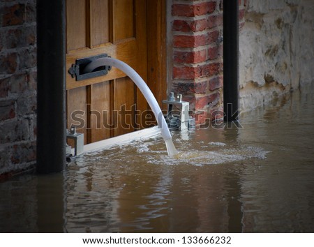 River water being pumped out of flooded house