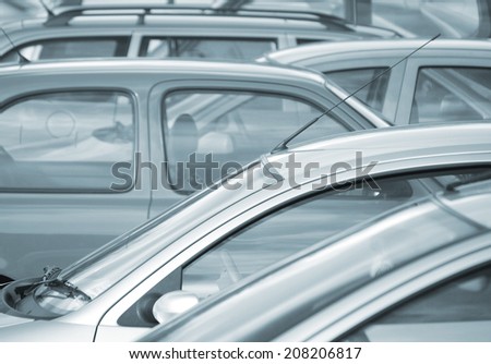 Telephoto image of cars parked in car park (blue toned)