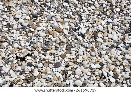 Closeup of smooth pebbles on beach. Makes an ideal background image for nautical themes.