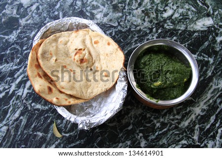 Indian meal: indian flat bread nan with meat in spinach sauce