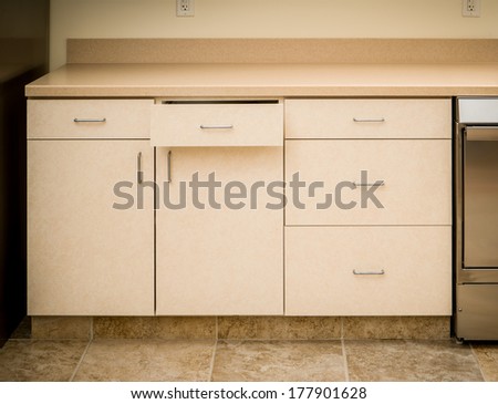 Empty tan kitchen counter and cabinet minimalist style with cabinet drawer open