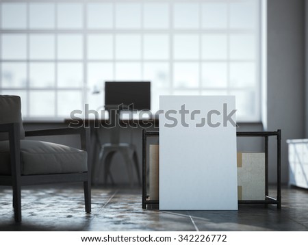 Blank white canvas near the table in loft interior.