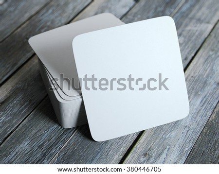 Stack of white square beer coasters