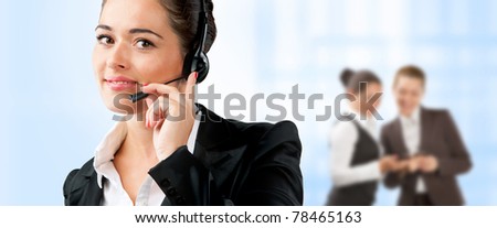 Portrait of friendly consultant with headset on the background of people