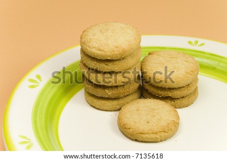row of orange cookies on a plate